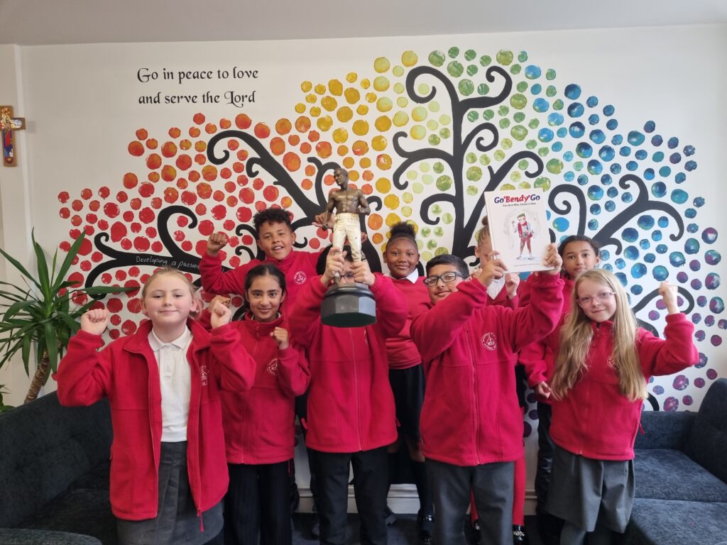 Pupils at Sneinton Primary School Nottingham celebrate with a ciopy of new book about Bendigo