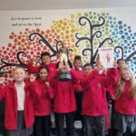Pupils at Sneinton Primary School Nottingham celebrate with a ciopy of new book about Bendigo